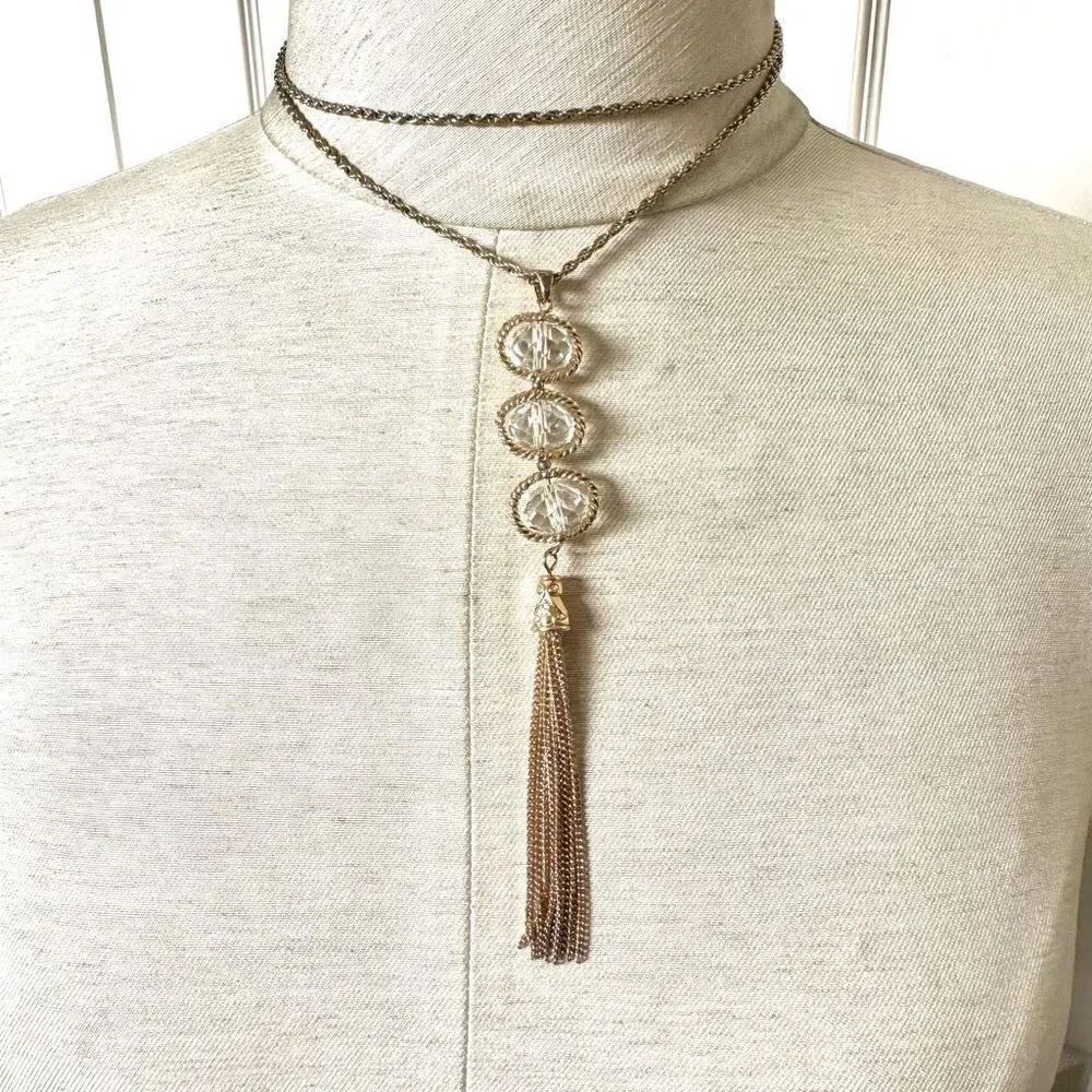 Long gold tone crystal tassel necklace